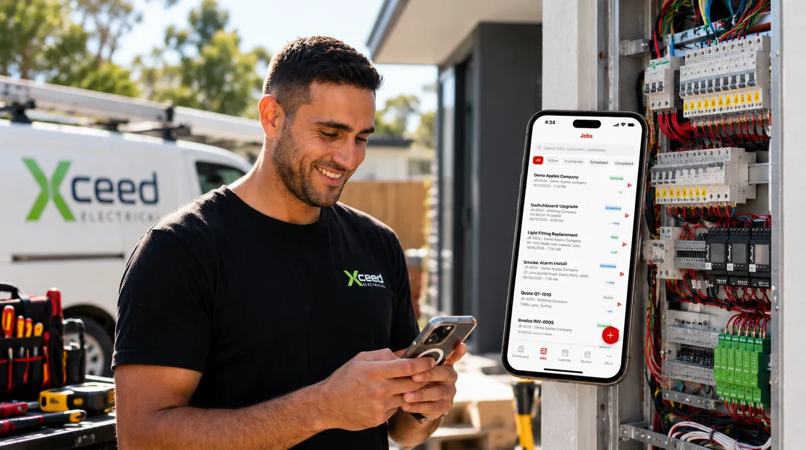 Jayson Conceicao on site beside an open switchboard and his work van, checking the jobs list in the TradieTally iPhone app